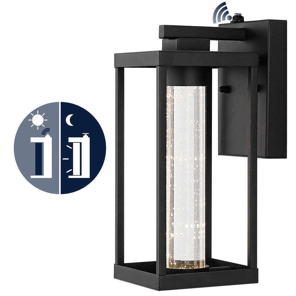 Juno 4.75 in. Black Hardwired Outdoor Cylinder Sconce Iron/Seeded Glass with Dusk - to - Dawn Sensor Integrated LED 1 - Light - Stu's Home Improvement Outlet