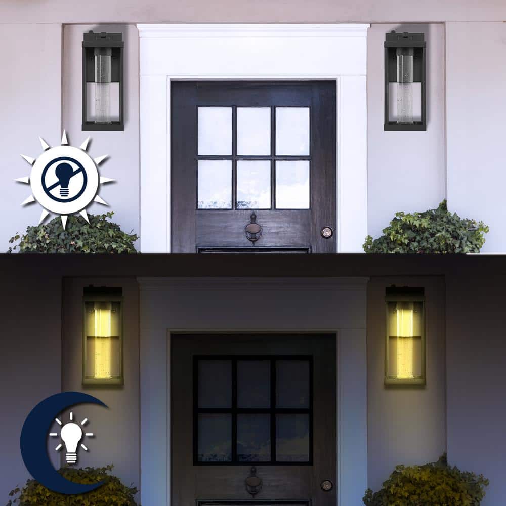 Juno 4.75 in. Black Hardwired Outdoor Cylinder Sconce Iron/Seeded Glass with Dusk - to - Dawn Sensor Integrated LED 1 - Light - Stu's Home Improvement Outlet
